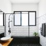 complete a contemporary bathroom with subway tile and black grout for shower walls with a wood floating vanity