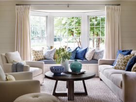 complete an elegant formal living room with bay window seating and multicolored pillows