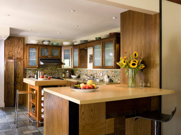 connect both spaces with a peninsula bar after removing the wall between your kitchen and dining room