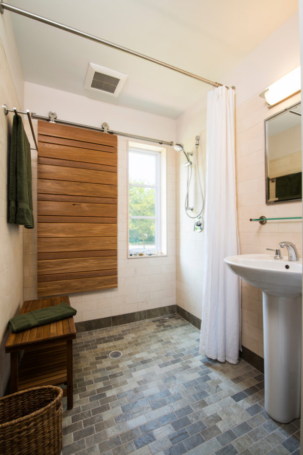 create a unique and cozy bathroom using medium-toned wood window shutters in barn door style