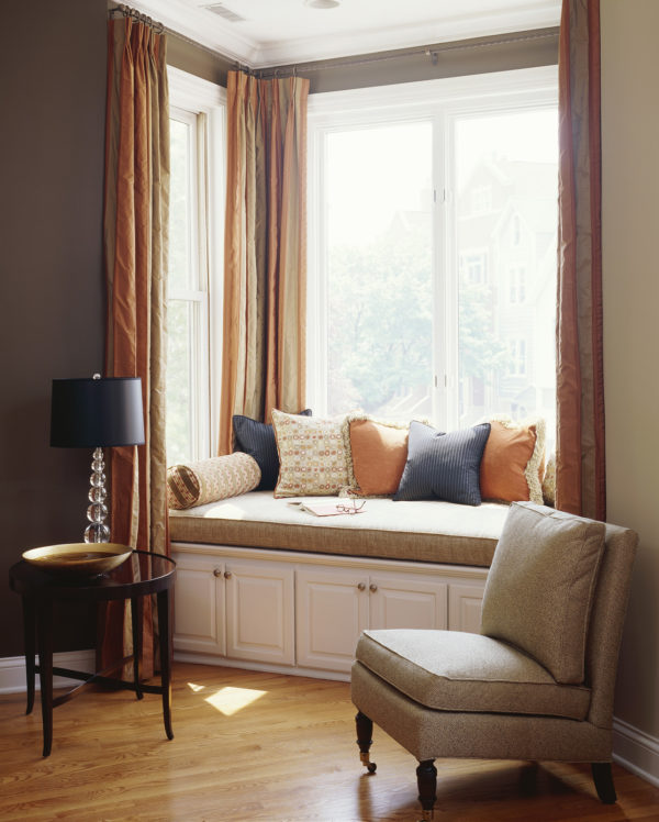 go with a warm orange tone for a welcoming living room with bay window
