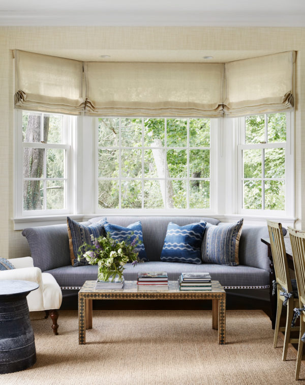 place an ornate grey sofa and coffee table in front of the bay window for a comfy living room