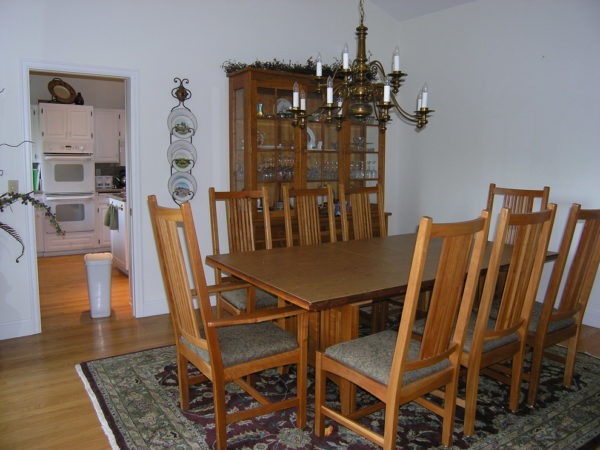 before: the cold, white walls and outdated carpet makes the dining room feel inhospitable