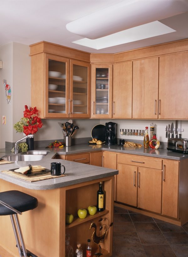 a small & earthy yet charming kitchen flaunts beautiful light brown maple cabinets