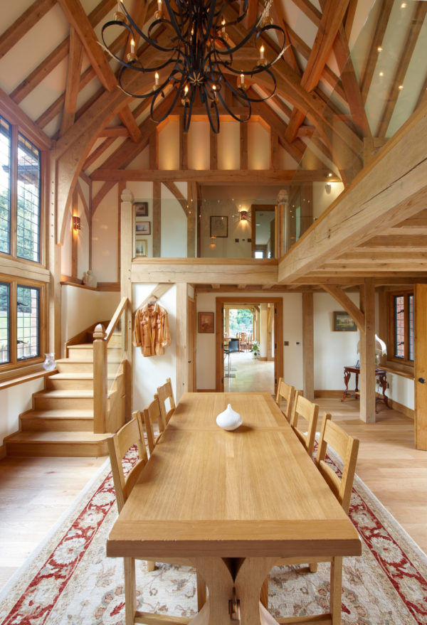 a timeless tudor style house interior with loft and medium toned wood materials