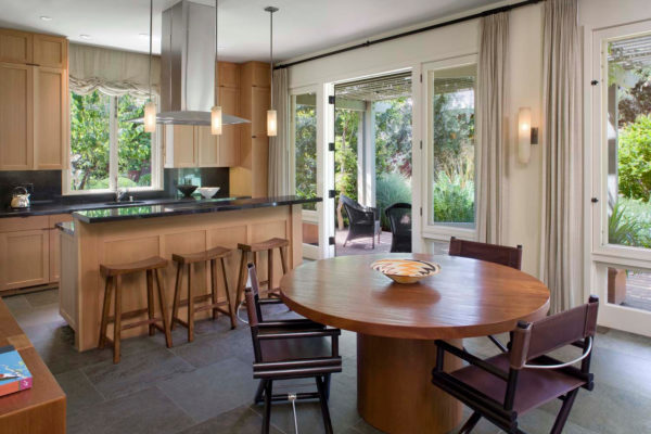 build an eat-in kitchen featuring light brown cabinets and camping-style dining chairs