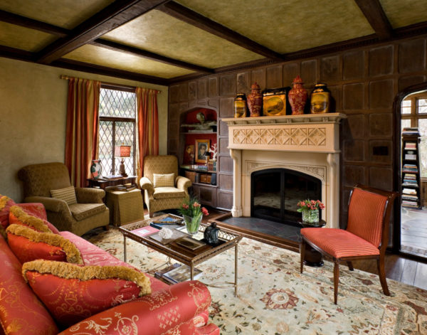 century-old fireplace in a tudor style house interior for a regal yet comfy living room