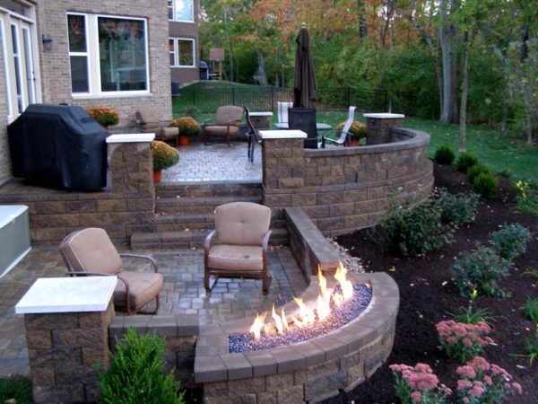 create a multi-level raised patio against the house with a fire pit for the perfect hang-out spot