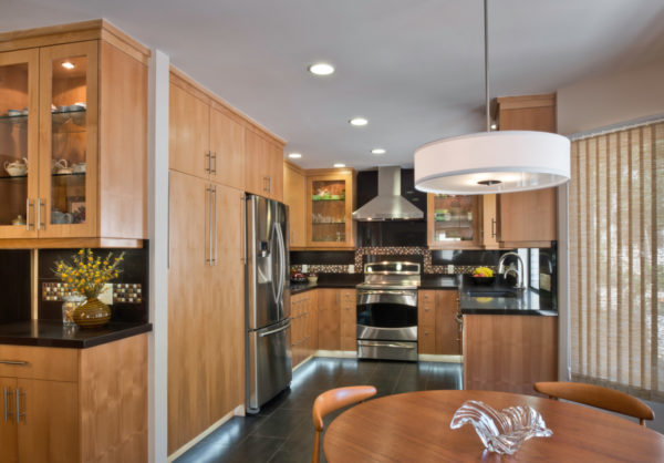 install floor to ceiling light brown kitchen cabinets and brown backsplash for an opulent effect
