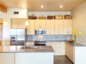 light brown cabinets look stylish with a grey backsplash in this southwestern kitchen