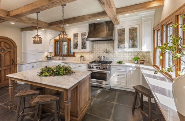 this beautiful kitchen flaunts a tudor style house interior by mixing wood, tiles, and marbles