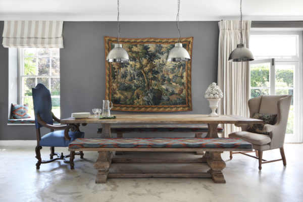 this tudor style house interior dining room uses dramatic landscape painting to raise the mood