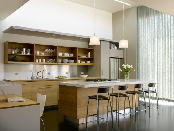 try a contemporary kitchen with an island bar, white walls, and light brown cabinets