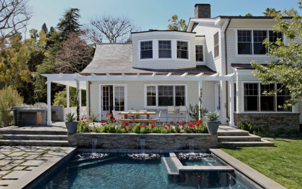 try a rectangular pool with a fountain and planters to complement your raised patio against the house