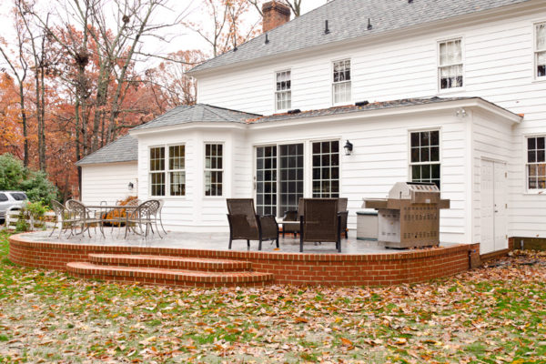 use glass doors and a raised patio against the house for the perfect entertaining space