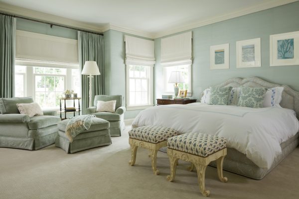 a blue, white, and gold color scheme in the bedroom can feel ultra-luxurious with roman shades and curtains