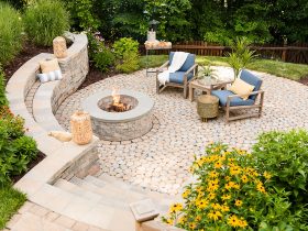 build a retaining wall fire pit with seating complete with rattan accents to evoke a cozy vibe