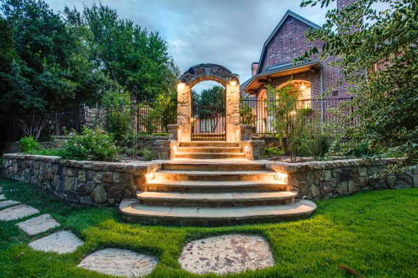 build landscaping slopes with rocks leading up to a dramatic archway for exotic retreat vibes