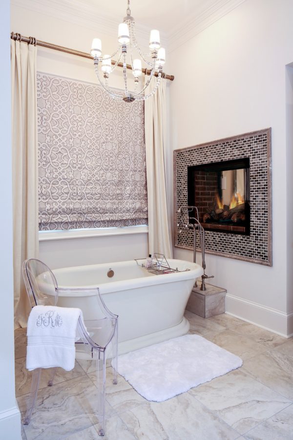 complete an elegant bathroom with a freestanding tub and roman shades with curtains