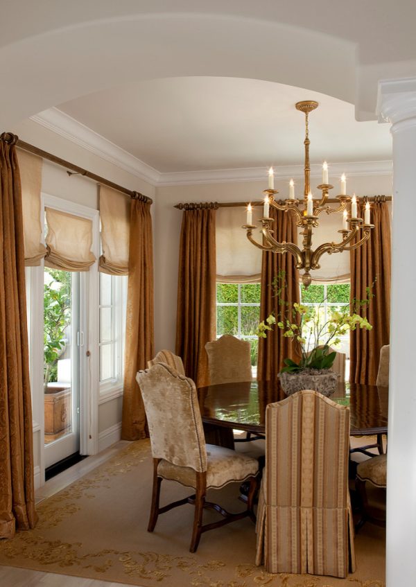 create an opulent dining room with roman shades, draping curtains, and traditional candelabra