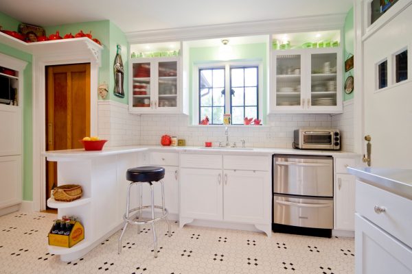 evoke the vintage appeal of a small kitchen with peninsula and tilework for the flooring and backsplash