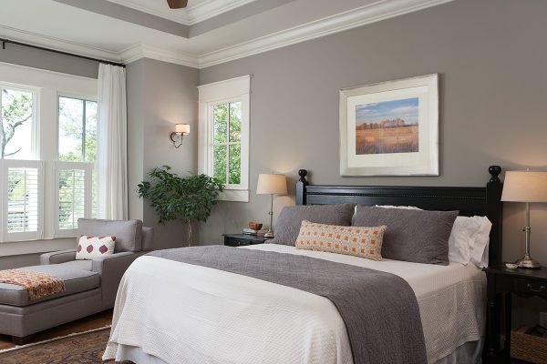 the gray pillows and white sheets look beautiful against the benjamin moore rockport gray walls and white dove trim in this bedroom