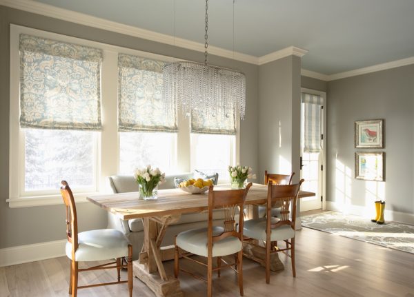 this beautiful dining room features benjamin moore's 1536 northern cliffs gray walls and acadia white oc-38 trim with stunning wood furnishing