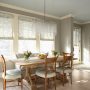 this beautiful dining room features benjamin moore's 1536 northern cliffs gray walls and acadia white oc-38 trim with stunning wood furnishing