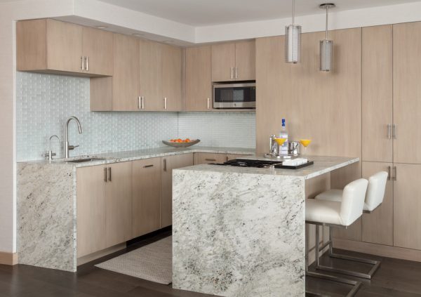 transform a corner space into a gorgeous small kitchen with a marble peninsula and wood cabinetry