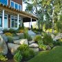 try a luscious front yard featuring landscaping slopes with rocks and ornamental grasses