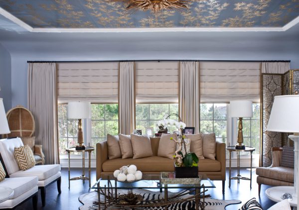 try complementing roman shades with gold curtains and blue walls for a lavish feel