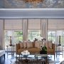 try complementing roman shades with gold curtains and blue walls for a lavish feel