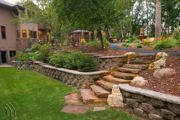 unique rock retaining walls and landscaping slopes with rocks evoke a casual charm to your yard