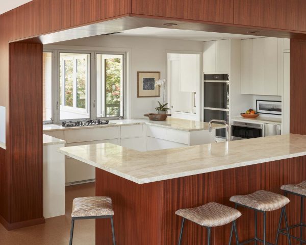 use unique architectural details to elevate your small, white and brown kitchen with a peninsula