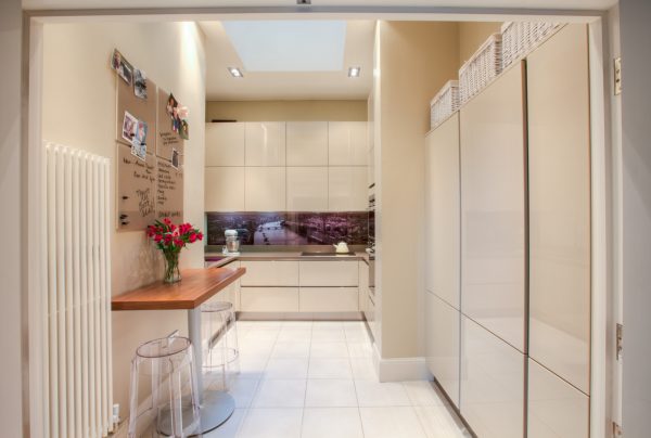 a contemporary styled white tile kitchen floor with a glossy finish evokes an inviting vibe