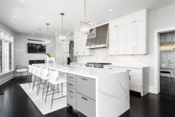 a kitchen with white cabinets and white countertops can look magnificent with a white rug and translucent chandelier