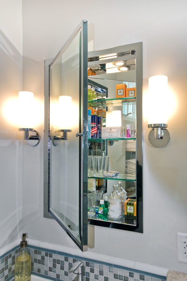 a modern bathroom with an all-glass recessed wall medicine cabinet between studs and bright pendant lamps