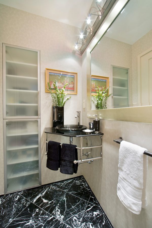 choose translucent doors for the powder room’s recessed wall cabinet between studs
