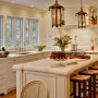 classic french country-inspired kitchen featuring benjamin moore linen white cabinets with white, honed calcutta marble countertops