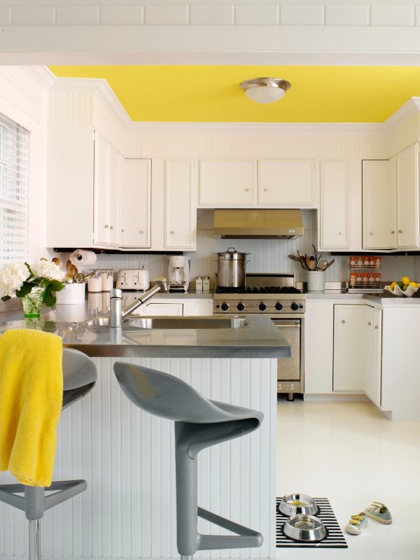 complement white tile kitchen floor with bright yellow ceiling for a cheerful mood
