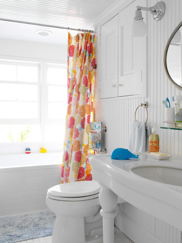 go for a white recessed wall cabinet between studs in a fun, beach-styled bathroom