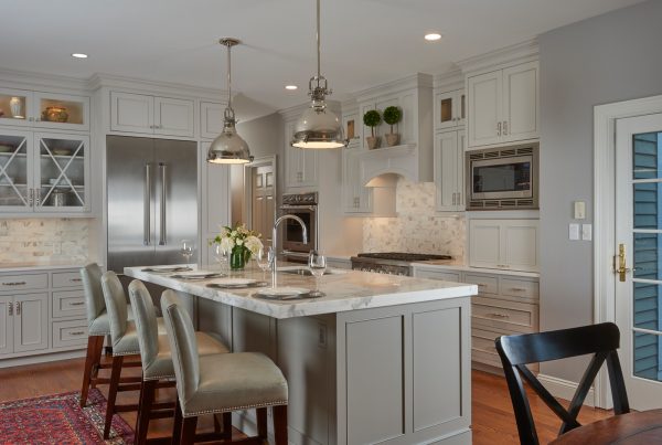 grey backsplash and warm wood flooring can add much warmth to white kitchen cabinets with white countertops