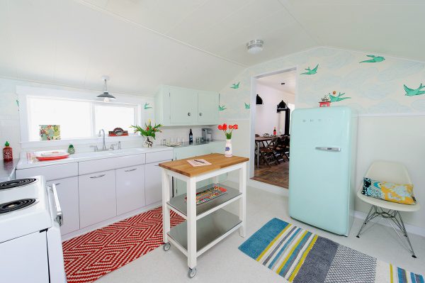incorporate playful colors to juxtapose white tile kitchen floor and cabinets