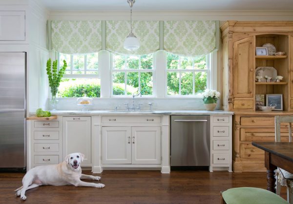 this vintage kitchen pairs wood and benjamin moore acadia white cabinets with white countertops to evoke a traditional charm