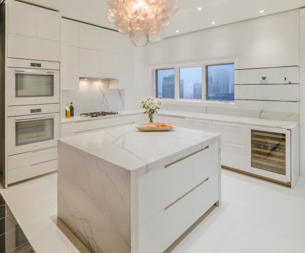 try an all-white kitchen, including a white tile floor, marble countertop, and backsplash