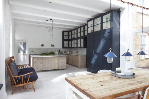try an industrial look with this white tile kitchen floor and stylish blue cabinets