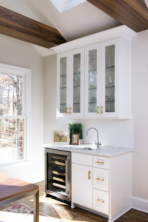 use white cabinets with white countertops for a bright and modern wet bar