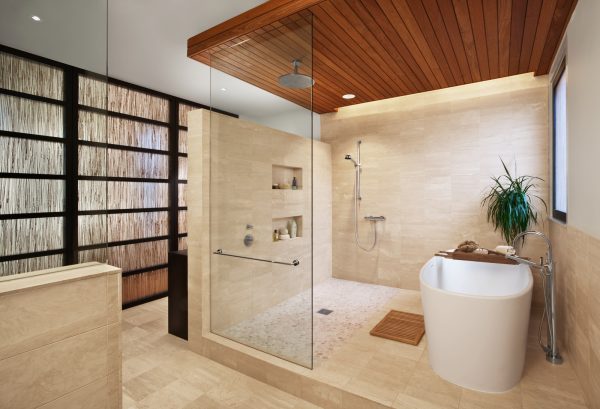 a contemporary zen bathroom with a built-in shower shelf, bathtub, and warm wood ceiling