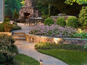 a stunning retaining wall cap idea filled with purple geraniums for a sophisticated garden