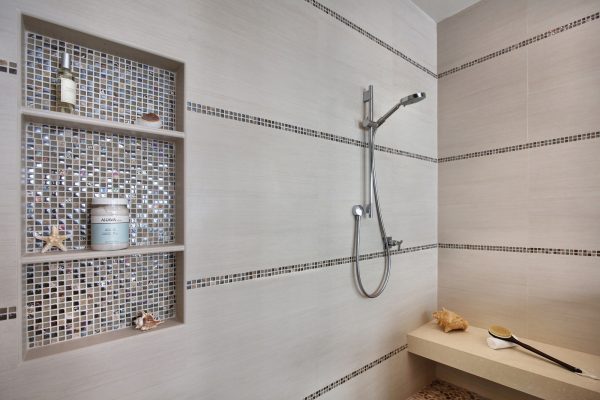 choose glass and stone mosaic for your built-in shower shelf to evoke a jazzy vibe